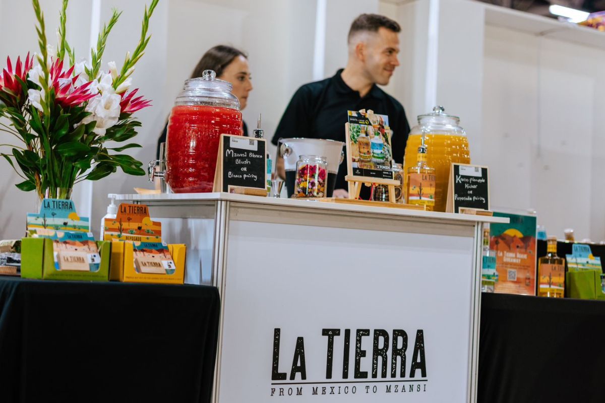 La Tierra Agave owners serving craft agave spirit at a South African agave event.